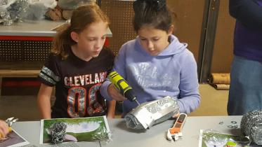 Two children building in the maker space