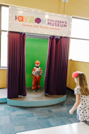 A child dressed as a firefighter on stage